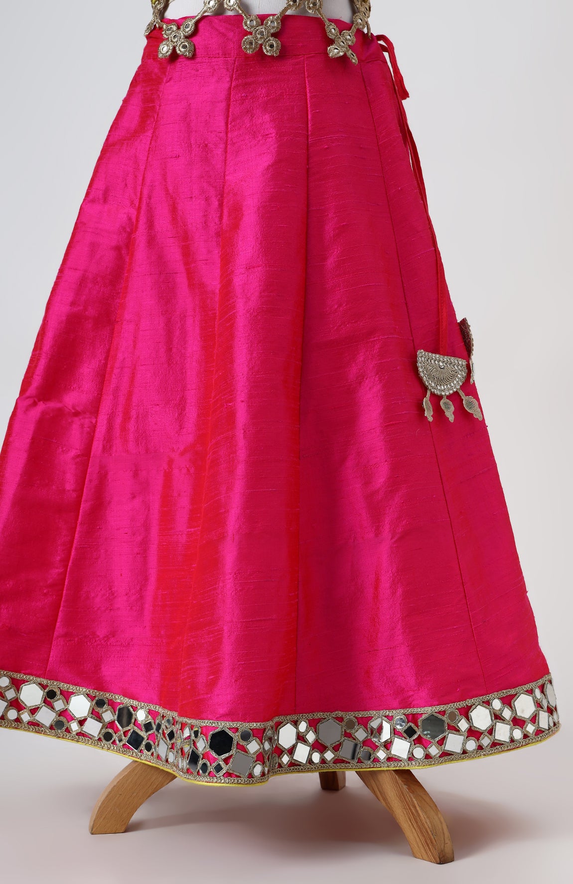 Raw silk blouse with faux mirror lace detailing and organza lehnga with gota detailing and mirrorwork border alongwith a soft net emb dupatta with pearl emb border