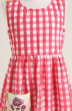 Cotton printed sleevesless checks Dress. Detailed with front Pocket and Back Criss Cross Wrap