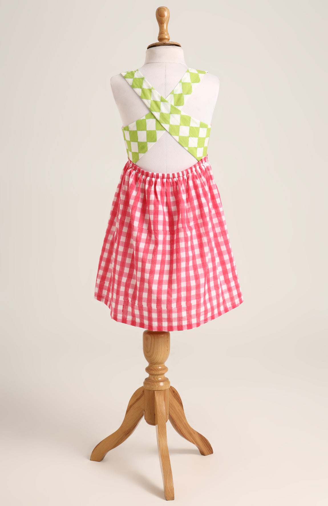 Cotton printed sleevesless checks Dress. Detailed with front Pocket and Back Criss Cross Wrap