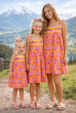 Printed cotton dress. Detailed with colourful strings on shoulder and  tied bow straps.